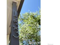 Closeup of house numbers on a pillar with tree and blue sky background at 1233 Carolina Ave, Longmont, CO 80501