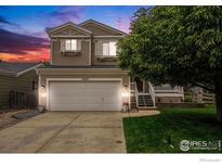 Charming two-story home features a two-car garage, well-maintained lawn, and inviting front porch at 1820 Gordon Dr, Erie, CO 80516