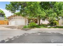 Charming ranch style home with mature trees, brick facade and attached garage at 1860 Hawthorn Ave, Boulder, CO 80304
