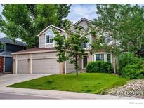 Charming two-story home with a three car garage, mature trees, and well-manicured landscaping at 2047 Erie Ln, Superior, CO 80027