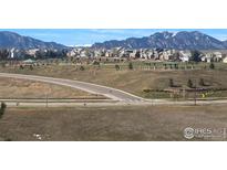 Beautiful neighborhood view with park, mountain backdrop, and well-maintained homes at 3223 Castle Peak Ave, Superior, CO 80027