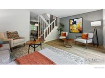 Bright living room boasts modern decor, natural light, and an inviting staircase to the upper level at 3363 Madison Ave # 121, Boulder, CO 80303