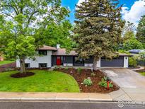 Charming home featuring a well-manicured lawn, mature trees and a welcoming exterior aesthetic at 365 Mohawk Dr, Boulder, CO 80303