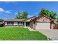 Charming single-Gathering home with a well-maintained lawn and inviting curb appeal on a sunny day at 633 S Galena St, Denver, CO 80247