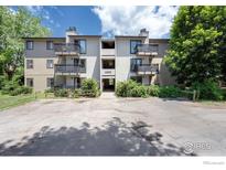 Inviting condo building featuring multiple units with private balconies and well-maintained landscaping at 6505 Kalua Rd # 104, Boulder, CO 80301