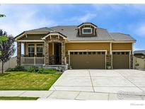 Charming single-Gathering home showcasing a well-manicured lawn and a three-car garage, complemented by stone accents at 1060 Arrowhead Ct, Erie, CO 80516