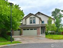 Charming two-story home featuring a two-car garage, well-maintained lawn, and inviting curb appeal at 1477 Akers Ct, Erie, CO 80516