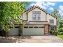 Charming two-story home featuring a three-car garage, well-maintained lawn and mature landscaping at 1477 Akers Ct, Erie, CO 80516
