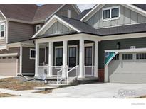 Charming home showcasing a welcoming front porch with elegant columns and fresh curb appeal at 1631 Poplar Dr, Erie, CO 80516