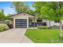 Charming single-story home with a modern garage door and well-maintained front yard at 2652 Sherwood Cir, Boulder, CO 80304
