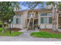 Inviting exterior view of a townhome featuring a private entrance with stairs and lovely landscaping at 6076 Gunbarrel Ave # F, Boulder, CO 80301