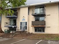 Exterior view of apartment building with balconies, stairs, and parking at 12172 Melody Dr # 101, Westminster, CO 80234