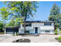 Charming two-story home with black painted garage door and a well-manicured gravel front yard at 12802 E Nevada Cir, Aurora, CO 80012