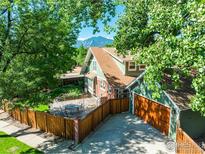 Charming home showcasing a spacious patio, lush yard, a mountain view, and an attached two car garage at 1717 Iris Ave, Boulder, CO 80304