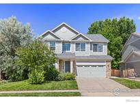 Charming two-story home with a well-manicured front yard and attached two-car garage at 183 Lister Way, Erie, CO 80516