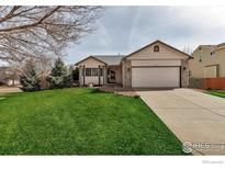 Charming home with a well-maintained lawn and mature trees, offering excellent curb appeal at 2132 Boise Ct, Longmont, CO 80504