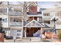 Attractive condo building featuring brick accents, private patios, and professional landscaping at 2201 Pearl St # 110, Boulder, CO 80302