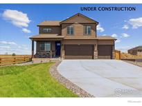 Charming two-story home with a three car garage, stone accents, landscaping and large driveway at 250 Chardon Ave, Brighton, CO 80601