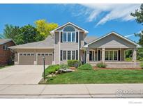 Charming two-story home with a well-manicured lawn, lush landscaping, and a three car garage at 4483 S Meadow Dr, Boulder, CO 80301