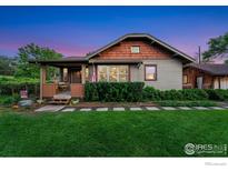 Charming home featuring a covered front porch, well-maintained lawn, and mature landscaping at 4900 W 6Th Ave, Denver, CO 80204