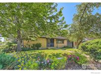 Charming single-story brick home with lush front yard landscaping and mature trees at 510 S 46Th St, Boulder, CO 80305