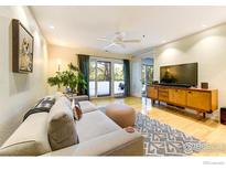 Inviting living room features modern furnishings, hardwood floors, and sliding glass doors to a balcony at 812 Walnut St # D, Boulder, CO 80302