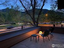 Outdoor patio with mountain views, lounge chairs, and stylish lighting, perfect for relaxing evenings at 812 Walnut St # D, Boulder, CO 80302