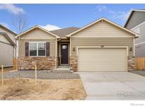 Charming single Gathering home featuring stone accents, two-car garage, and neutral colored siding at 874 Ledge St, Lochbuie, CO 80601