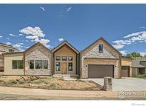 Inviting stone accented home with a two car garage and modern architectural design at 1126 W Enclave Cir, Louisville, CO 80027