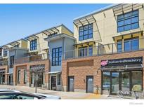 Modern townhomes feature brick and stucco exteriors with large windows, offering urban living at 1200 Yarmouth Ave # 237, Boulder, CO 80304