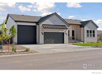 Charming single-Gathering home boasting an attached three-car garage and a well-manicured front lawn at 1425 Burt Ave, Berthoud, CO 80513