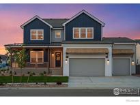 Charming two-story home with a covered front porch and a two car garage featuring lovely architectural details at 1426 Swan Peter Dr, Berthoud, CO 80513