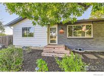 Charming home featuring a brick facade, modern windows, and a welcoming wood entry at 1498 Wicklow St, Boulder, CO 80303