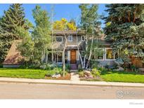 Charming two-story home with mature trees and lush landscaping enhancing its curb appeal at 3490 16Th Cir, Boulder, CO 80304