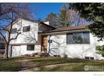 Charming two-story home with stone walkway and white brick exterior at 3635 Buckeye Ct, Boulder, CO 80304