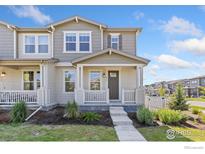 Charming two-story home features neutral siding, covered porch, and well-manicured lawn, located in a desirable neighborhood at 450 Canadian Crossing Dr, Longmont, CO 80504