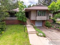Charming home featuring a unique facade, a well-maintained lawn, and a convenient attached garage at 525 13Th St, Boulder, CO 80302