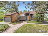 Charming single-story home with stone pathway and lush landscaping at 916 W Alder St, Louisville, CO 80027