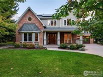 Charming two-story home boasts a well-manicured lawn and inviting front porch at 1107 Juniper Ave, Boulder, CO 80304