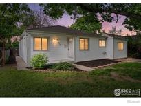 Charming single-story home features a manicured lawn, complemented by fresh paint and updated landscaping at 1111 Wabash St, Denver, CO 80220