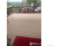 Spacious wooden deck with railings, perfect for outdoor relaxation and enjoying the surrounding greenery at 14751 E 24Th Ave, Aurora, CO 80011