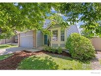 Charming two-story home with a well-manicured lawn, mature trees and a brick-accented facade at 1667 Reliance Cir, Superior, CO 80027