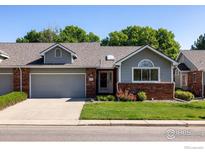 Charming single-story home with a well-manicured lawn, brick accents, and a two-car garage at 1922 15Th Ave, Longmont, CO 80501