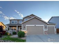 Charming two-story home features a spacious three-car garage and covered front porch at 1931 Rannoch Dr, Longmont, CO 80504