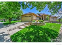 Charming home featuring a stone exterior, well-manicured lawn, and inviting curb appeal at 2226 Eagles Nest Dr, Lafayette, CO 80026