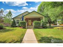 Charming brick home with a welcoming front porch and well-manicured lawn at 301 E Colorado Ave, Berthoud, CO 80513