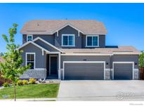 Beautiful two-story home with a three-car garage, stone accents, and well-maintained landscaping at 3308 Dryden Pl, Mead, CO 80542