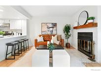 Comfortable living room with a fireplace, leather sofa, and open layout to the kitchen at 5920 Gunbarrel Ave # D, Boulder, CO 80301