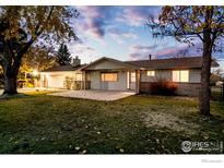 Charming single-story home with mature trees and a well-maintained lawn at 8895 Morton Rd, Niwot, CO 80503