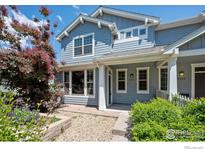 Charming blue home featuring well-maintained landscaping and a welcoming front porch at 9273 W 107Th Pl, Broomfield, CO 80021